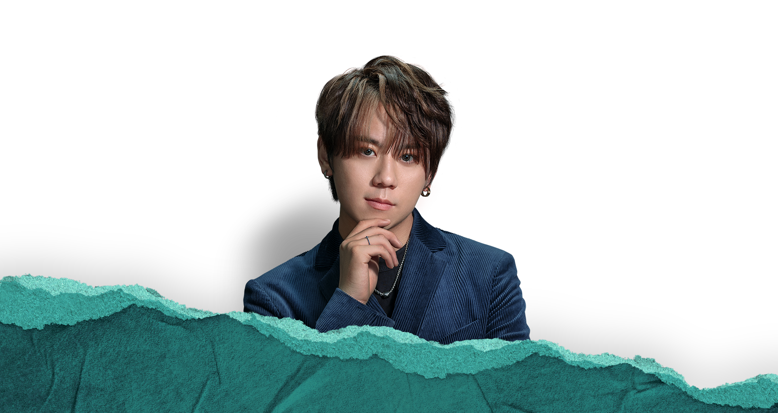 A confident Keung To on top of green teared paper background